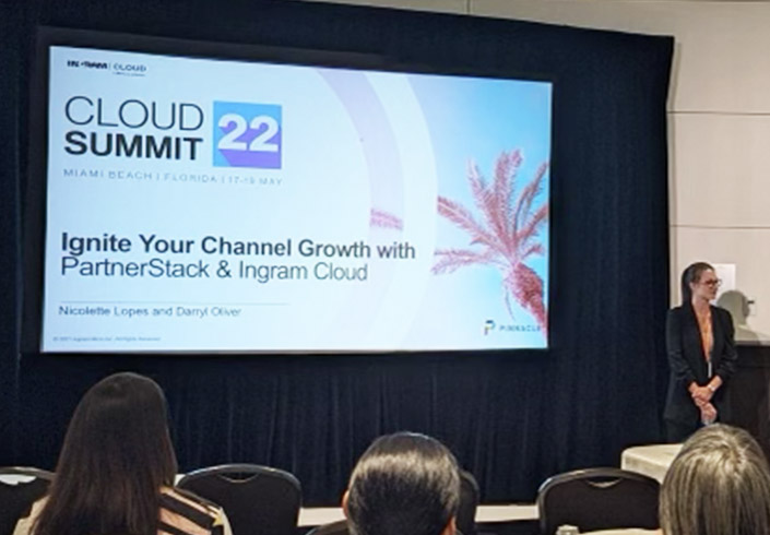Projection screen featuring Cloud Summit 2022 with text that reads Ignite Your Channel Growth with PartnerStack and Ingram Cloud
