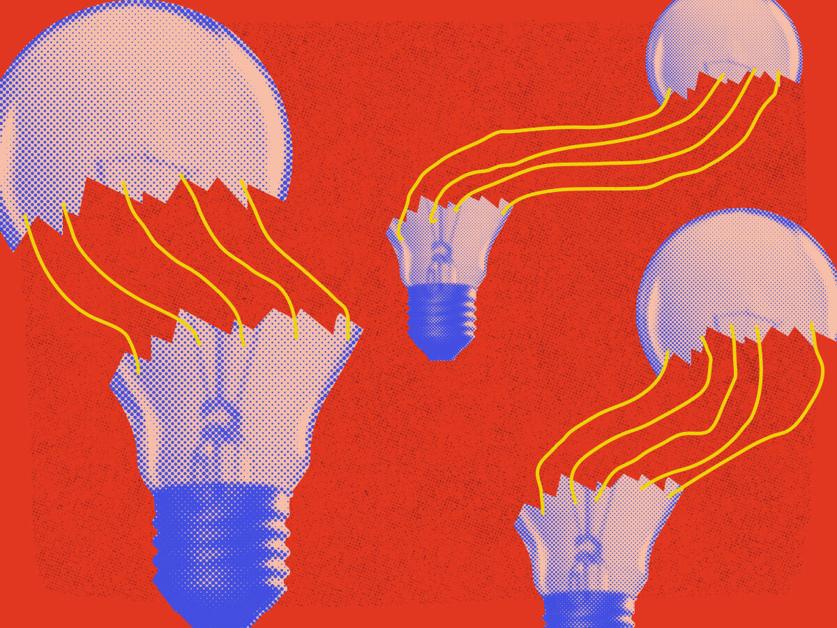broken lightbulbs with ties in between the parts on a red background